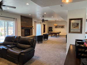 Carpeted living room featuring a textured ceiling, pool table, visible vents, and recessed lighting