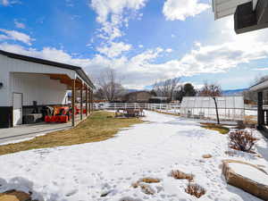 Snowy yard with an outbuilding