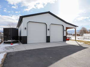 Snow covered garage with a mountain view