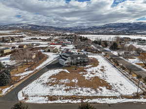 Snowy aerial view featuring a mountain view