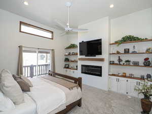 Carpeted bedroom featuring ceiling fan and access to exterior