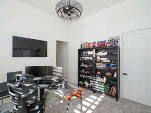 Carpeted office with a high ceiling