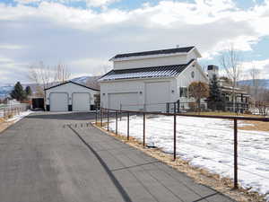 Exterior space with an outbuilding and a garage