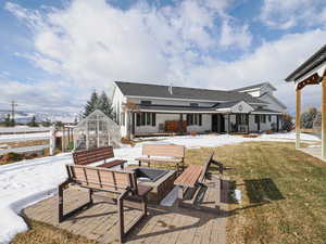 Back of house with an outbuilding, a lawn, and a patio