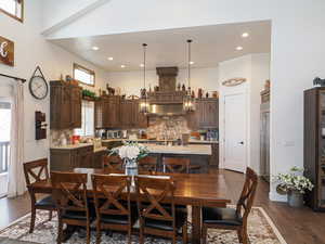 Dining room featuring a towering ceiling and dark hardwood / wood-style floors