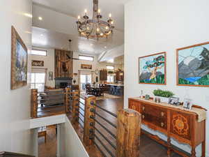 Dining area with dark hardwood / wood-style flooring and a towering ceiling