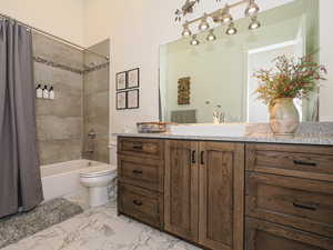 Full bathroom featuring toilet, vanity, and shower / bath combo