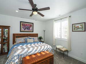 Carpeted bedroom with ceiling fan