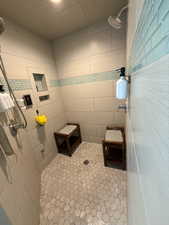 Full bathroom with tile patterned flooring and a tile shower