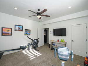 Workout area featuring carpet floors and ceiling fan