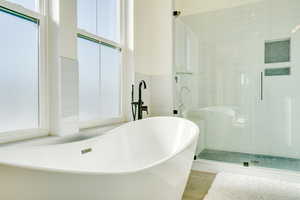 Bathroom featuring tile patterned floors and plus walk in shower