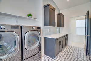 Washroom with cabinets and independent washer and dryer