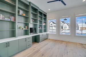 Unfurnished office featuring light wood-type flooring and ceiling fan