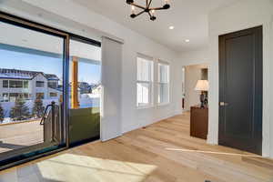 Interior space with hardwood / wood-style flooring and an inviting chandelier