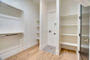 Walk in closet featuring wood-type flooring