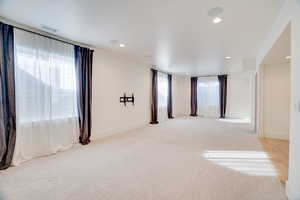 Spare room featuring light colored carpet