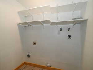 Laundry area featuring tile patterned flooring, washer hookup, and hookup for an electric dryer