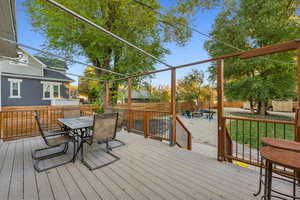 Xeriscaped Backyard Oasis with composite deck, shade trees and two sheds