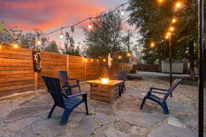 Patio terrace at dusk featuring 2 storage sheds. Perfect for your firepit.