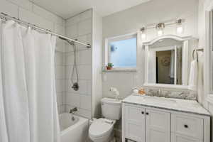 Full bathroom with toilet, shower / bathtub combination and vanity