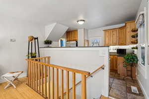 Stairway down to basement with bamboo wood-style flooring