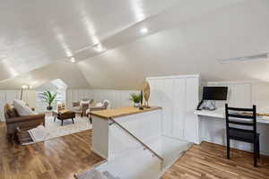 Office space/Den featuring vaulted ceiling and hardwood / wood-style flooring