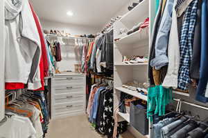 Walk in closet with light carpet