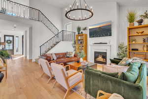 Living room featuring light hardwood / wood-style floors and a high ceiling