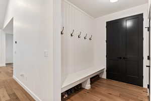 Mudroom with light hardwood / wood-style floors