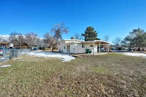 Back of house with a patio area and a yard