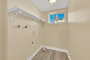 Laundry room featuring wood-type flooring, hookup for an electric dryer, and hookup for a washing machine