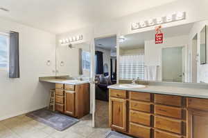 Master Bathroom featuring private toilet, tile patterned floors, plenty of natural light, and vanity with double sinks