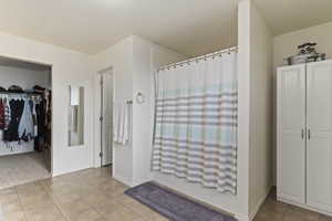 Master Bathroom featuring tile patterned floors and shower / bath combination with curtain