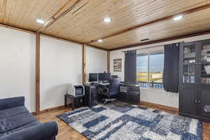 Office/den area featuring wooden ceiling and hardwood flooring