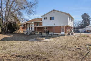 Rear view of house featuring a fire pit