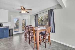 Dining room featuring a textured ceiling, a wealth of natural light, and french doors