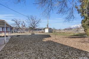 View of yard with a mountain view and a shed