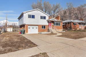 Tri-level home with a garage and a mountain view