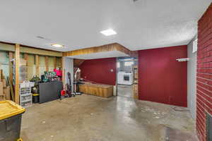 Basement featuring washer / clothes dryer and a textured ceiling