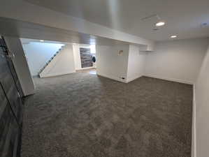 Basement with washer / dryer and dark carpet