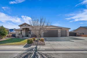 View of front of home with a front yard and a garage