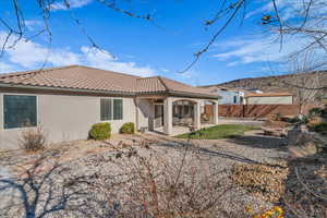 Back of property with a patio