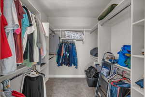 Spacious closet with carpet flooring