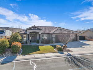 View of front of house featuring a front lawn and a garage