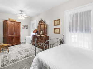 Bedroom with ceiling fan and carpet flooring