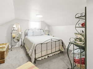 Bedroom with carpet and lofted ceiling