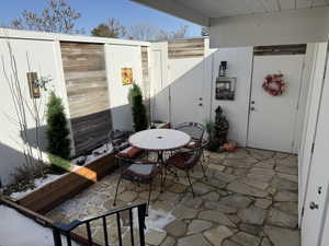 Lower level private patio including flagstone, flower boxes and decorative water fountain.