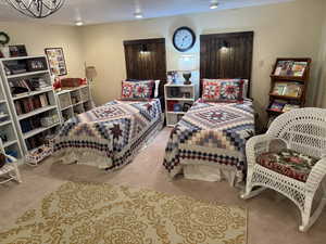 Family room with light colored carpet and a textured ceiling