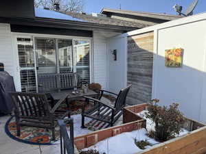 Private patio including flagstone, flower boxes and decorative water fountain.