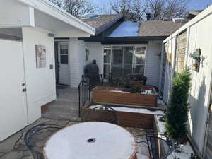 Lower level private patio including flagstone, flower boxes and decorative water fountain.